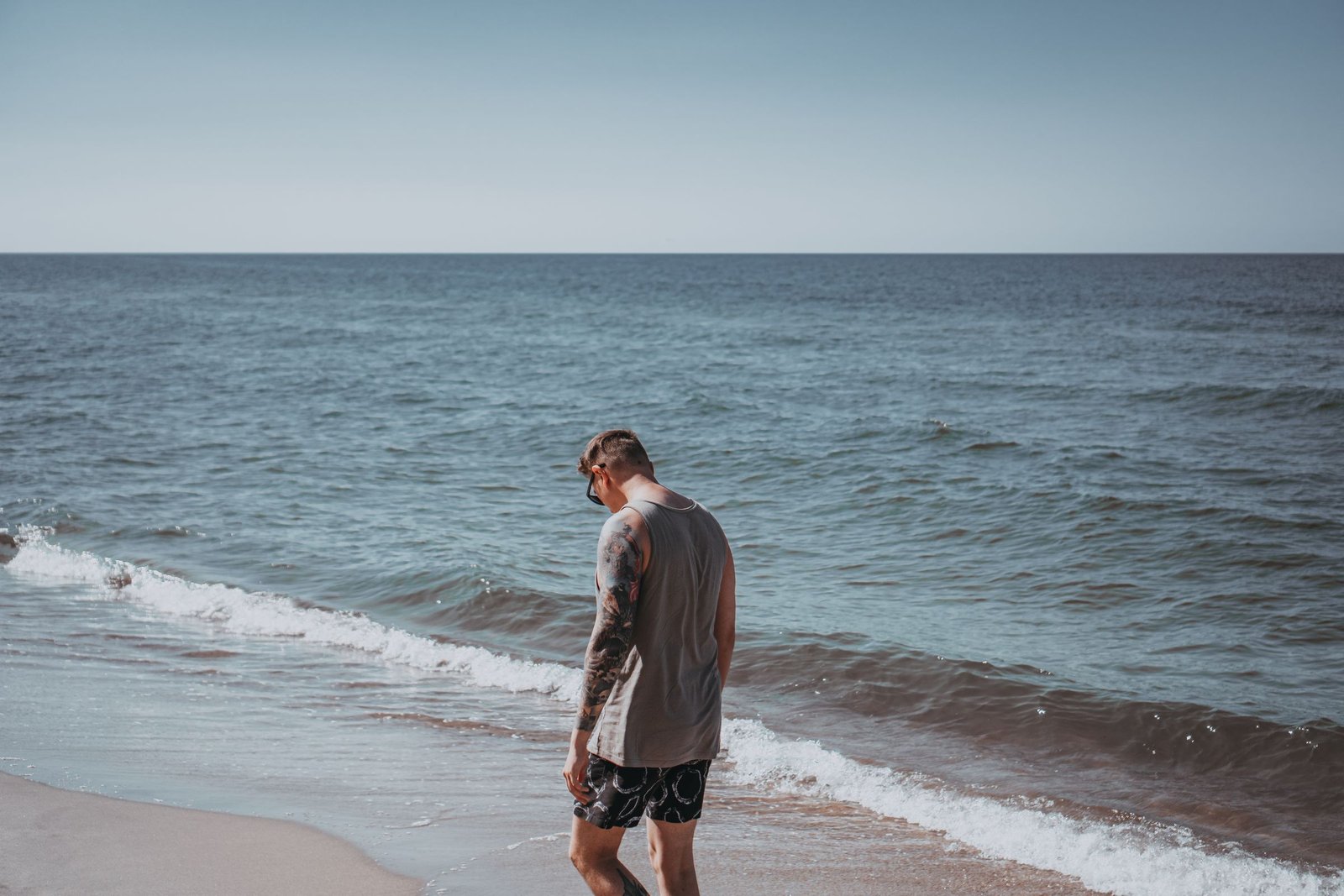 Ticker Summer 2026 campaign — relaxed seaside in a basic t-shirt